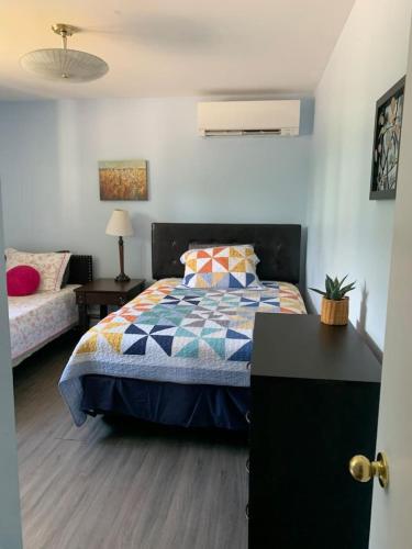 a bedroom with a bed and a couch at Tranquil Retreats on Robinson in Moncton