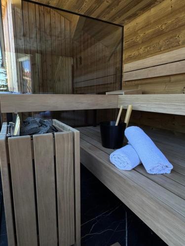 two towels sitting on a wooden shelf in a sauna at Das Zehnerkar Chalet - Klippitztörl in Kliening