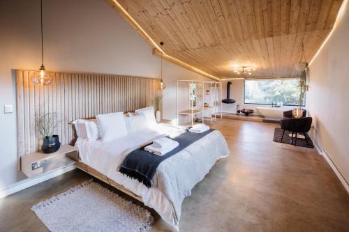 a bedroom with a large bed and a living room at Rosemary Hill Farm in Pretoria