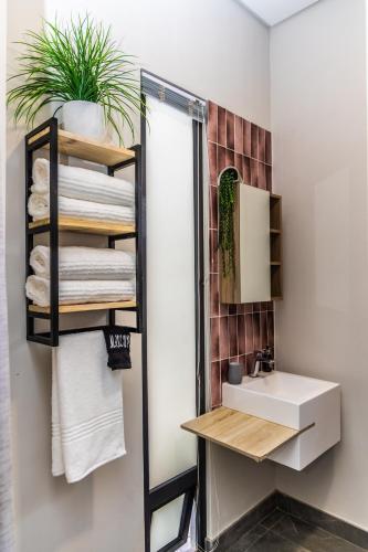 a bathroom with a sink and a mirror at 4 Lulworth in Johannesburg