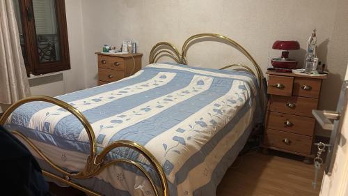 a bedroom with a bed with a blue and white comforter at SENRa in Marco de Canaveses