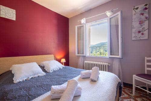 a bedroom with two beds and a window at La maison de flavie in Sainte-Cécile-dʼAndorge