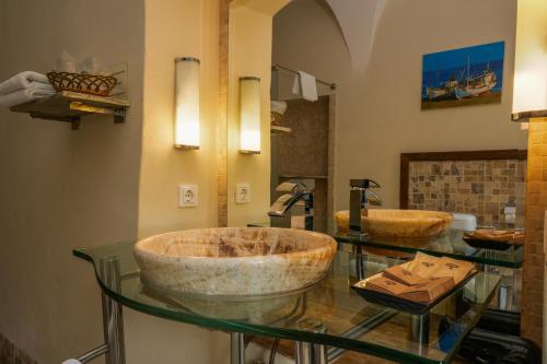 a bathroom with two sinks on a glass counter at Fronius Boutique Residence in Sighişoara