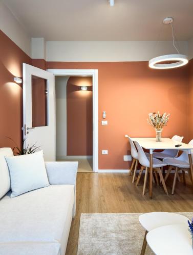 a living room with a couch and a table at All Seasons Apartments - Free Parking & City Center in Shkodër