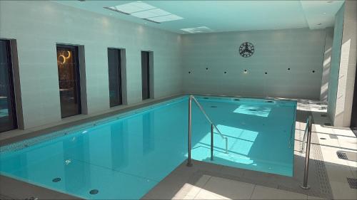 a large swimming pool in a building at Domitys - Galilée in Cergy