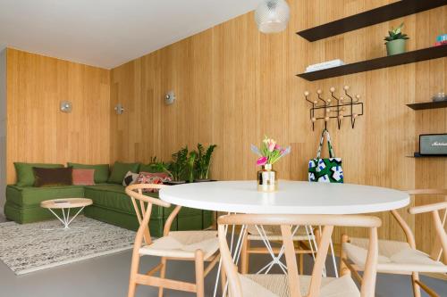 a living room with a green couch and a table at Kith & Kin Boutique Apartments in Amsterdam