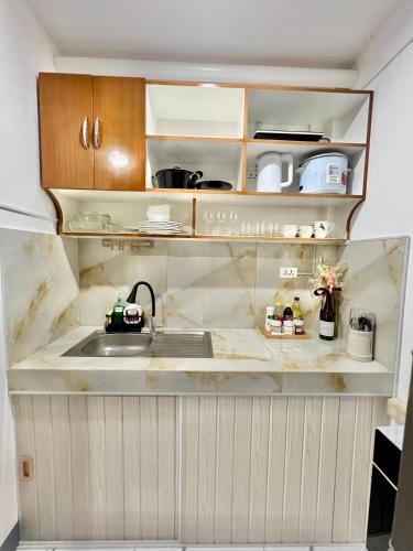 a kitchen with a sink and a counter at J&D Fully-Aircon 400mbps Parking WiFi 6pax in Canaman