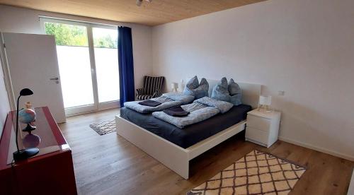 a bedroom with a bed with blue pillows on it at Ferienhaus Licht-Blick 9 in Wiltingen
