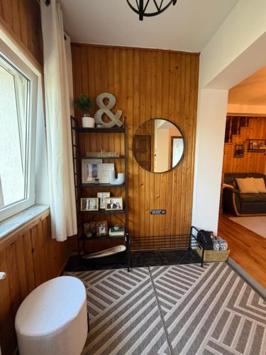 a living room with a mirror and a stool at Vacation with Purpose in Gura Humorului