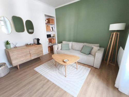 a living room with a couch and a table at Logis cosy du centre ville in Aix-les-Bains