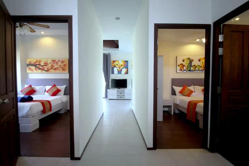 a room with two beds and a mirror at Chaba Villa at Had Yao Beach in Had Yao Beach