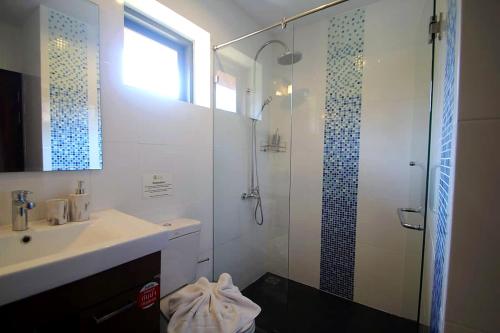 a bathroom with a shower and a sink and a showerspective at Chaba Villa at Had Yao Beach in Had Yao Beach
