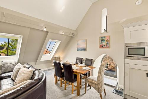 a kitchen and dining room with a table and a couch at 5 Old Templars - North East Escapes in Spittal