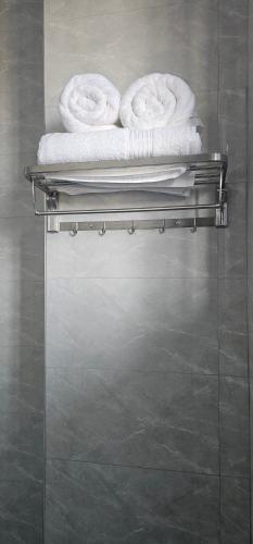 two towels on a towel rack in a bathroom at Cornerstone Hotel Arusha in Arusha