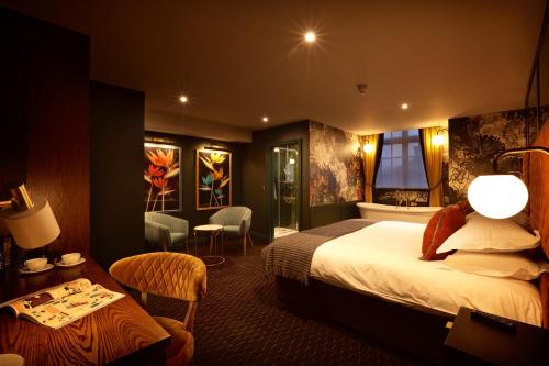 a hotel room with a bed and a table at The Bedford Balham - Live Music Venue in London