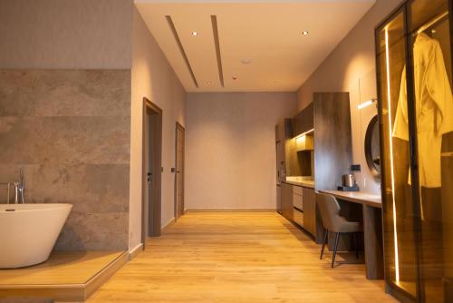 a bathroom with a white tub and a sink at Grande Candor Exclusive Hotel in Warri Airport
