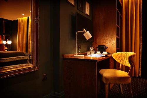 a room with a desk with a lamp and a chair at The Bedford Balham - Live Music Venue in London