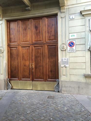 a large wooden door on the side of a building at La Terrazza Di Arturo Guest House in Turin