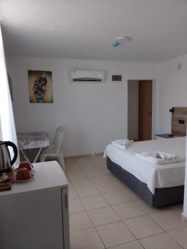 a hotel room with a bed and a table at Fethiye Apart Otel in Fethiye
