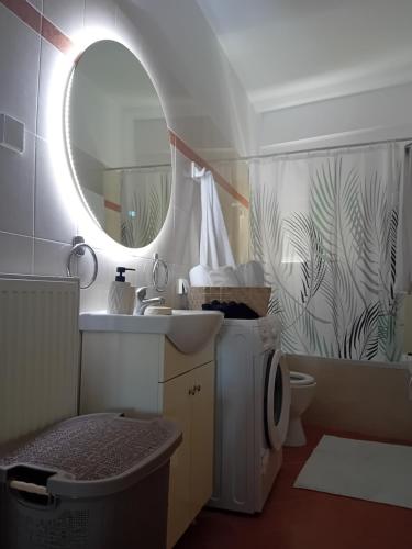 a bathroom with a sink and a mirror and a toilet at Mondo Piccolino in Samos