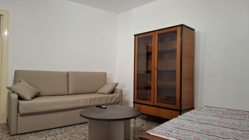 a living room with a couch and a cabinet at Casa vacanze Donna Santa in San Marco dʼAlunzio