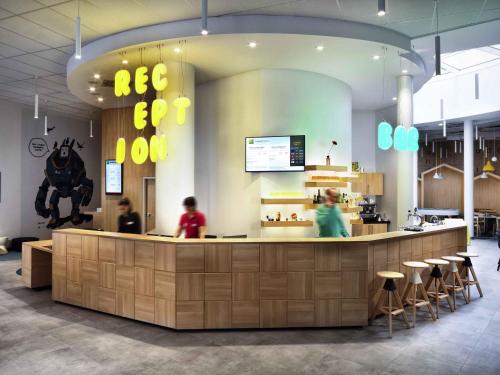 a restaurant with people sitting at a counter at Ibis Styles Budapest Center in Budapest