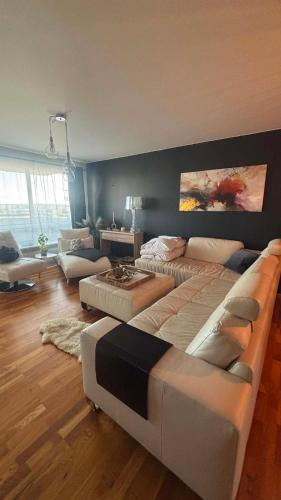 a living room with two beds and a couch at Akranes Sunset Apartment in Akranes