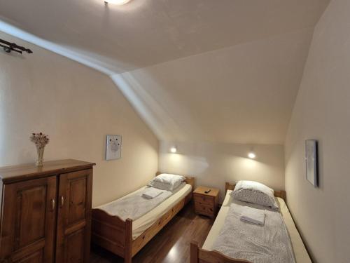 two beds in a room with a ceiling at PENSIUNEA BIO in Coltău