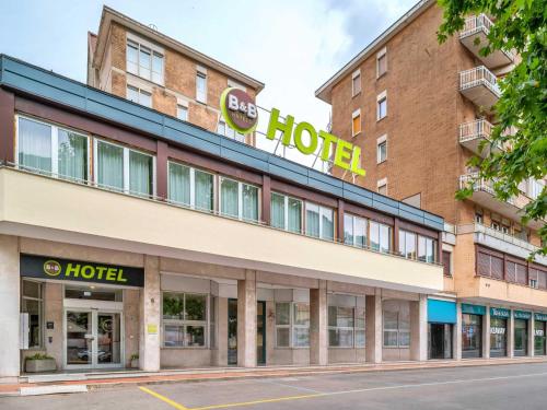 a hotel building with a hotel sign on it at B&B Hotel Como City Center in Como
