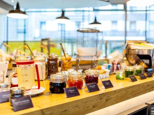 a counter with many jars of jam on it at ibis Hotel Hamburg St. Pauli Messe in Hamburg