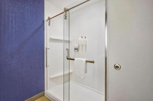 a shower with a glass door in a bathroom at Fairfield by Marriott Middletown Monroe in Middletown