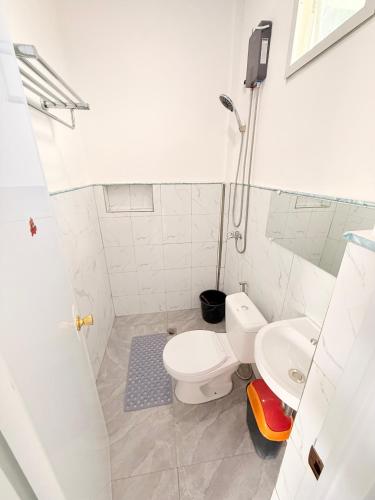 a bathroom with a toilet and a sink at Olliz Huvila in Siquijor