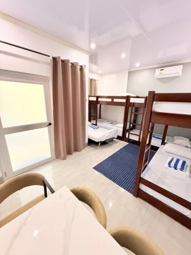 a dorm room with two bunk beds and a window at Olliz Huvila in Siquijor