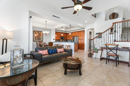 a living room with a couch and a table at Mauna Lani Fairways 903 in Waikoloa