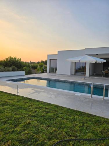 a villa with a swimming pool and a house at Elia Serenity House in Anarita