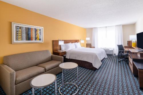 a hotel room with a bed and a couch at Garner Hotel Macon West by IHG in Macon