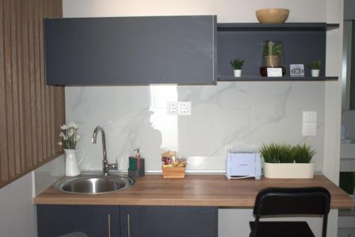 a kitchen with a sink and a counter top at Siel Residences in Perea