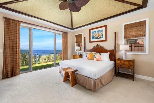 a bedroom with a bed and a large window at Holua Kai 21 in Kailua-Kona