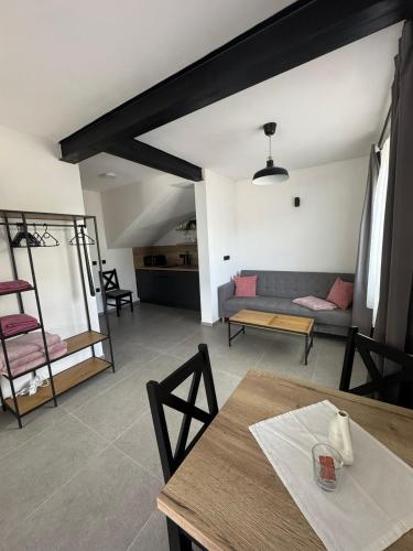a living room with a table and a couch at Penzion Mlýn Cibotín in Česká Bělá