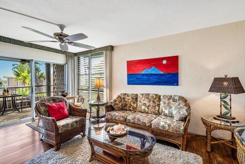 a living room with a couch and a table at Alii Villas 309 in Kailua-Kona