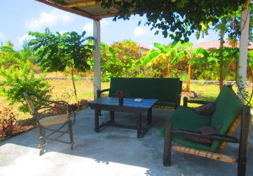 a patio with a table and chairs under a gazebo at Maku House in Makunduchi
