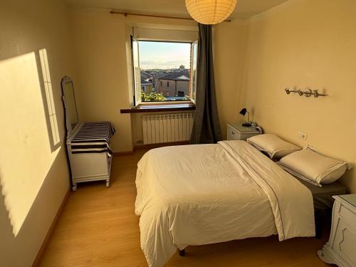 a bedroom with a large bed and a window at El encanto de un pueblo in Grajal de Campos