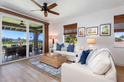 a living room with a white couch and a ceiling fan at Halii Kai 11D in Waikoloa