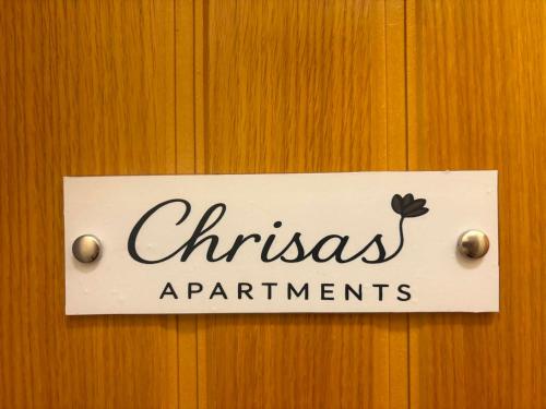 a sign on a door that says christmas apartments at Chrisa's Apartments 1 in Missolonghi