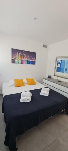 a bedroom with a large bed with towels on it at Les chambres de Dolce in Bandol
