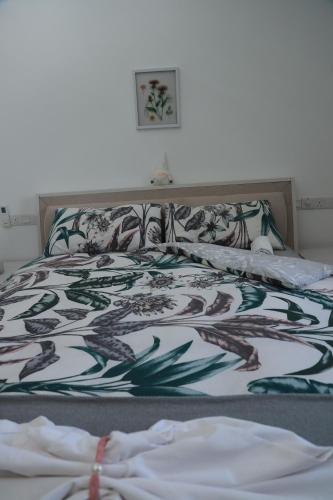 a bed with a blanket on top of it at PL BEACH FRONT APARTMENT in Bopitiya