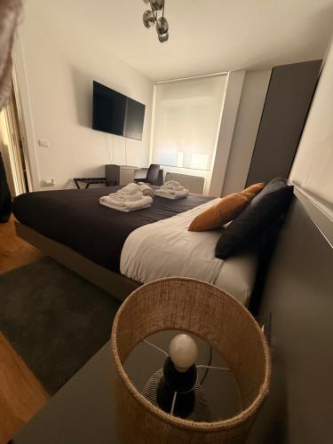 a bedroom with a large bed with a mirror at Cedrino suite apartment in Cagliari