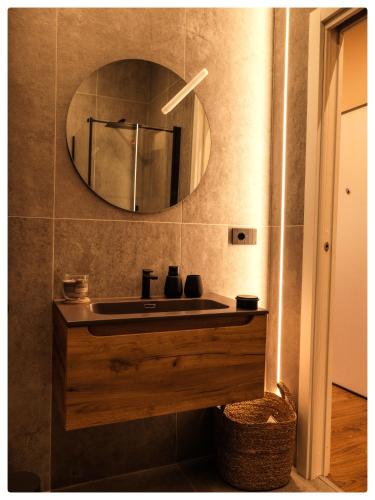 a bathroom with a sink and a mirror at Adapartament in Vercelli