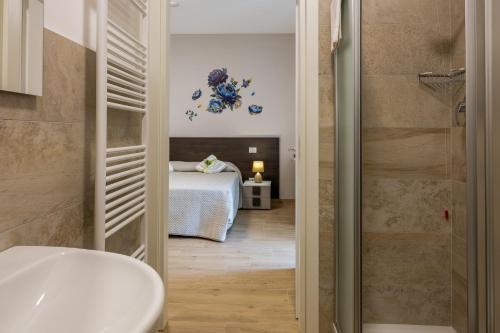a bathroom with a sink and a bed in a room at Villa Paradiso in Pioraco
