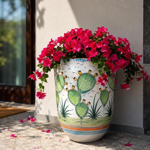 a vase filled with red flowers and cactus at Ognissanti Rooms in Acireale